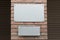 Mockup template with two blank metallic boards on building facade
