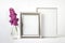 Mockup template with two blank silver frames and pink lilac flower branch in glass vase