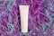 Mockup of a tube of cream, lots of colored purple packing paper filler