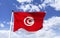 Mockup of Tunisia Flag fluttering under blue sky