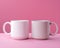 Mockup two white coffe cup or mug on a pink background with copy space. Blank template for your design