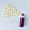 Mockup of unbranded brown plastic spray bottle and chamomiles on a pastel gray background. Natural organic spa cosmetics