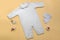 Mockup of a white baby bodysuit on a colored background close-up with red pants and gnomes mockup of clothes for