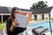 Mockup of a white blank hardcover book featuring a woman reading it near a pool