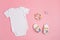 Mockup of white infant bodysuit made of organic cotton with eco friendly baby accessories