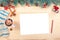 Mockup white paper on christmas background. a white sheet of paper with space for text lies on a light wooden table with Christmas