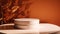 Mockup of a white podium with sea buckthorn branches and tangerines.