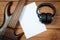 Mockup with a white sheet of paper with a guitar and headphones for music themes and drawings