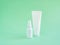 Mockups of two unbranded white bottle for branding and label on a green background. One of them is squeeze bottle plastic tube.