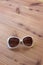 Mod vintage frame on woman sunglasses, white with mod sides, rhinestones, on wood background