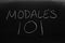 Modales 101 On A Blackboard.  Translation: Manners 101