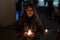 Model with black jacket in night photo with candles