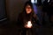 Model with black jacket in night photo with candles