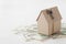 Model of cardboard house with key and dollar bills. House building, loan, real estate, cost of housing or buying a new home concep