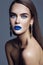 Model with colorful makeup with blue lips and jewelry