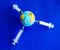 The model earth on the syringe on blue background- image
