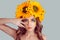 Model in floral headband touching her face skin around eyes