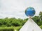 A model globe is placed on a triangular platform