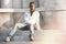 Model handsome man relaxed sitting on the steps of white marble.