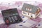 Model house, calculator and five hundred euro