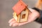 Model of a house in the girlâ€™s hand, the concept of buying a home on credit or a mortgage. The concept of safe and affordable