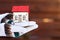 Model of house at hands, outdoors. Protecting and isolating house. Winter. Real estate and property concept. Small miniature of