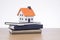 Model of house standing on pile of notebooks