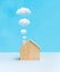 Model of Househome made by wood with cloud from smokestack on pastel color background.Property and estate or  environment,