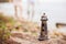 Model lighthouse on the rocky beach