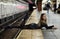 Model lying at the edge of subway platform.