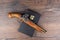 Model old retro muzzle loader flintlock pistol on top of a bible on a wooden table.