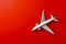Model passenger airliner on a red background