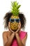 Model with pineapple in hands. African American Girl with Exotic Fruit. Cheerful woman with a smile relaxing on vacation. Image