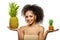 Model with pineapple in hands. African American Girl with Exotic Fruit. Cheerful woman with a smile relaxing on vacation. Image