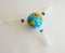 Model planet earth on syringes on white background - image