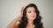 Model posing in the studio. Closeup of a woman in a golden crown looking straight in the camera while she poses in the