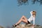 Model reclining on rocks, shows off her long legs