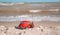 Model of a retro Volkswagen Beetle on a background of a sandy beach in Los Angeles