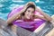 Model in rubber ring in swimming pool