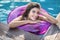 Model in rubber ring in swimming pool