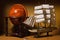 Model sailing ship and old globe