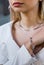 Model showcases a stunning luxurious diamond bracelet on her wrist in the jewelry boutique. The girl is adorned with