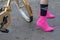 Model wears a pair of fuchsia shoes with heels and fuchsia socks