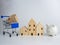 Model wooden house and piggy bank and shopping cart On a white background. Housing business concept