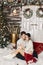 Model young woman and her handsome boyfriend posing in winter rustic interior decorated for New year with artificial