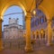 Modena - The porticoes on the Piazza Grande square at dusk with the Dome