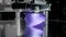 Modern 3d printer creates purple futuristic object