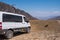 Modern 4x4 offroad camper mersedes-benz sprinter on gravel road in the mountains. Summer vacation. Summer road trip