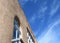 A modern adobe building with sky and clouds