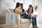 Modern air humidifier and blurred family on background